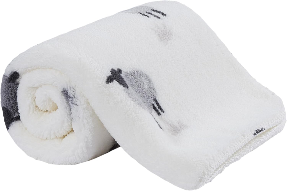 Cozy Sherpa fleece baby blanket folded on a crib